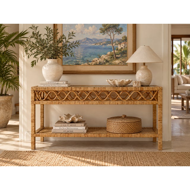 Beautiful vintage coastal rattan console table featuring a natural honey-toned finish, decorative wavy rattan detailing,...