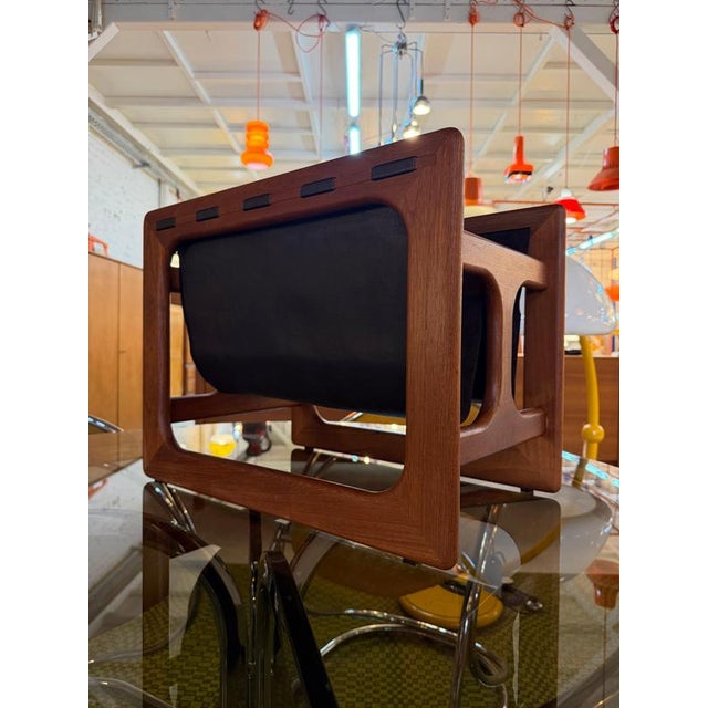 A masterpiece of Danish craftsmanship and timeless elegance: This magazine rack, crafted from teak and fine genuine...