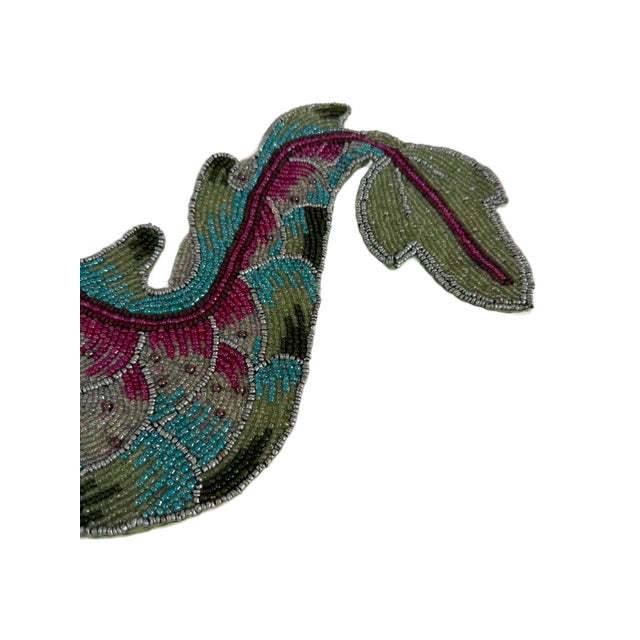 This is contemporary Decorative table runner by Kim Seybert, featuring an elaborate dragon motif rendered entirely in...