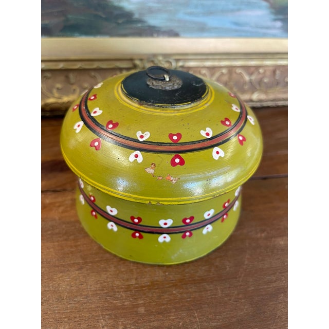 Charming vintage lidded wooden box featuring a hand-painted olive-green lacquer finish adorned with rows of red and white...