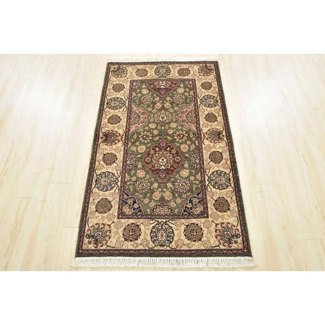 A traditional Tabriz rug hand-knotted with an all-wool pile on a cotton foundation. This finely woven oriental rug...
