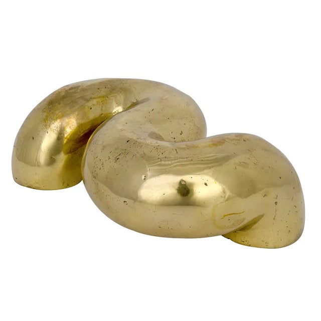 Organic curves are captured in brass in this unique accent piece.