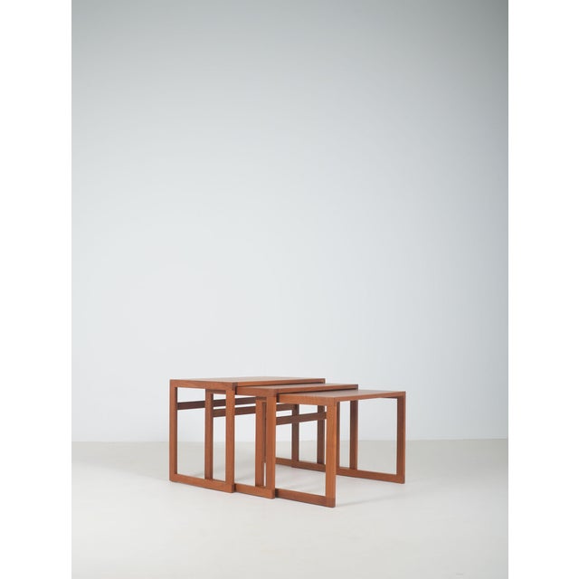 A set of three Danish nesting tables designed in the 1960s. These are made of teak by Vildbjerg Møbelfabrik. This piece is...