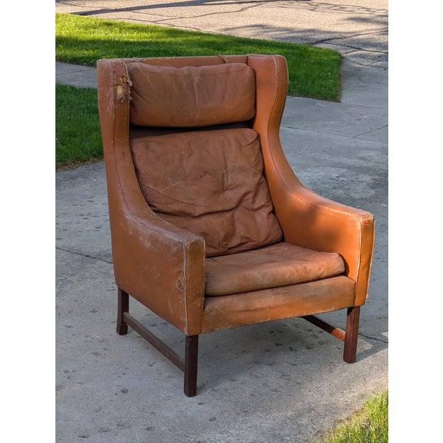 Listed is a Fredrik Kayser style (untagged) Lounge Chair with rose wood legs. These chairs resemble the Borge Mogensen...