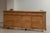 Rattan sideboard produced around 1970 in Italy. This bamboo sideboard on elegant feet has 4 doors and drawers with a...