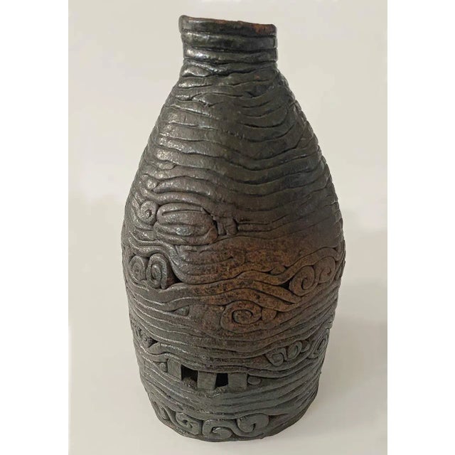 Late 20th century studio glazed pottery. Coil pattern throughout as well as color variations.