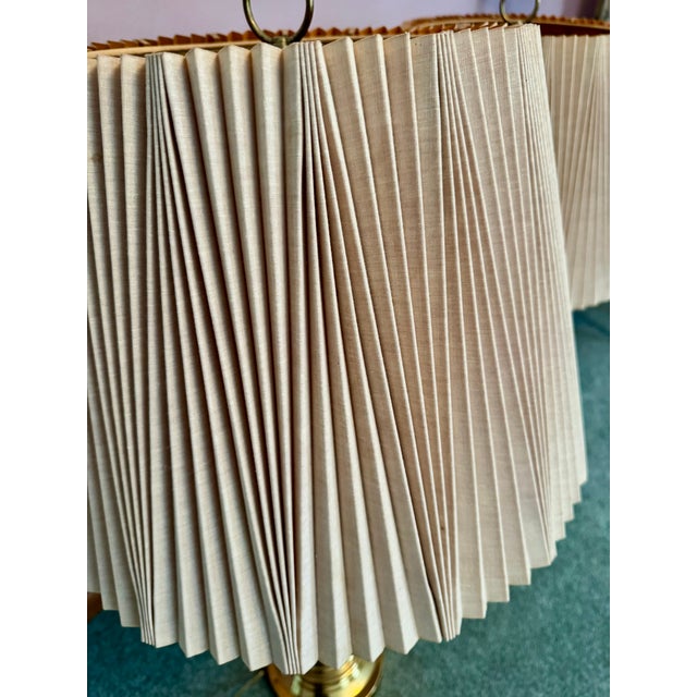 A timeless pair of vintage Stiffel solid brass urn-form table lamps. Both lamps retain their original pleated fabric...