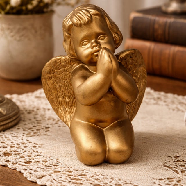 Vintage Caffco gold cherub figurine depicts a kneeling angel in a prayerful pose. This charming piece features a matte...
