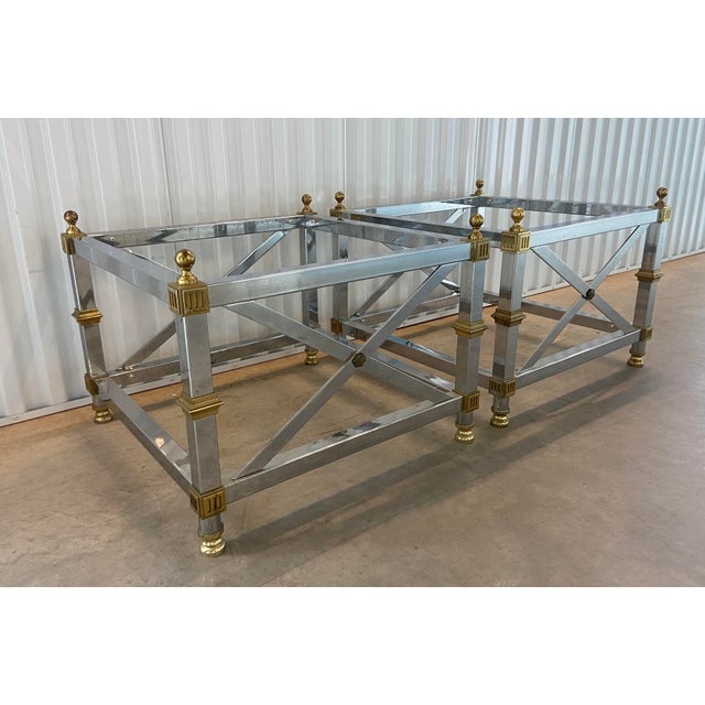 A beautiful pair of vintage mid to late 20th century chrome and brass end tables in the style of Maison Jansen. These are...