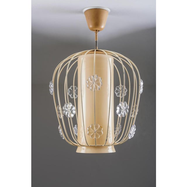 Decorative swedish pendant light in painted metal and glass, model 11510 by böhlmarks. The design is defined by its cage-...