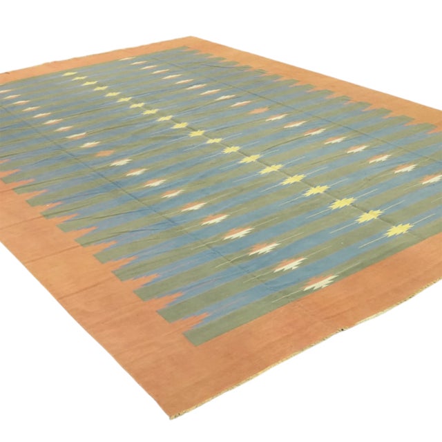 This vintage 10x15 Dhurrie flat weave is an exciting new entry in Rug & Kilim’s esteemed collection. Handwoven in wool, it...