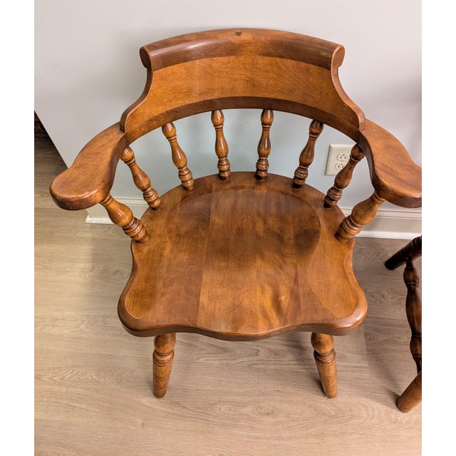 Stunning pair of vintage 1970s Ethan Allen pub-style captain's chairs from the iconic Heirloom Collection. Crafted in the...