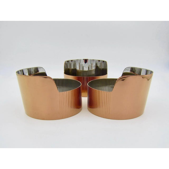 A set of three Georg Jensen bowls for snacks or trinkets in stainless steel with a warm and reflective copper-colored and...