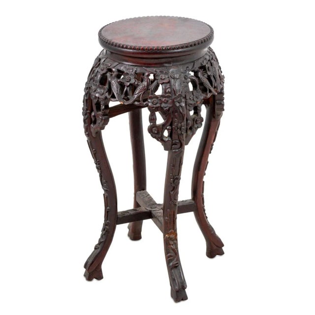 Chinese Carved Hardwood Pedestal Table, late 19th century, the circular top above a pierced foliate carved frieze, on...