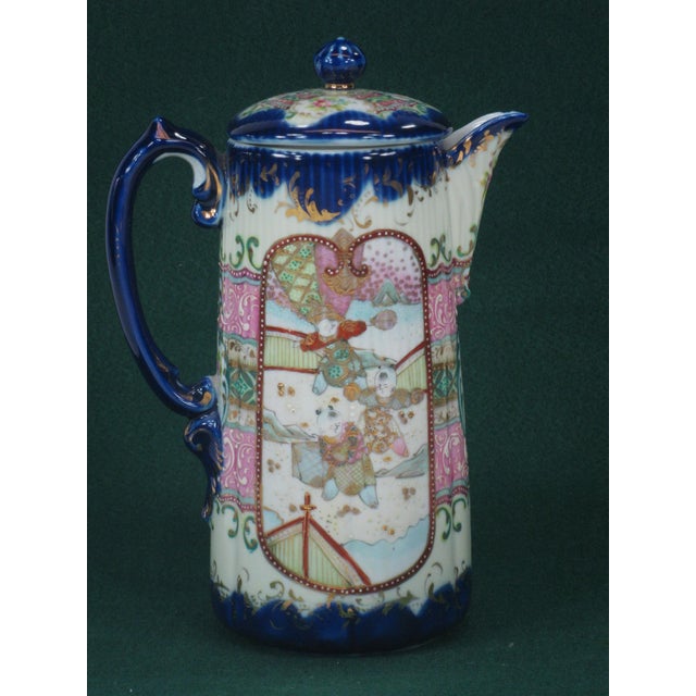 This is an antique Japanese Satsuma chocolate pot featuring an Oriental figurine design. Hand-painted on porcelain in the...