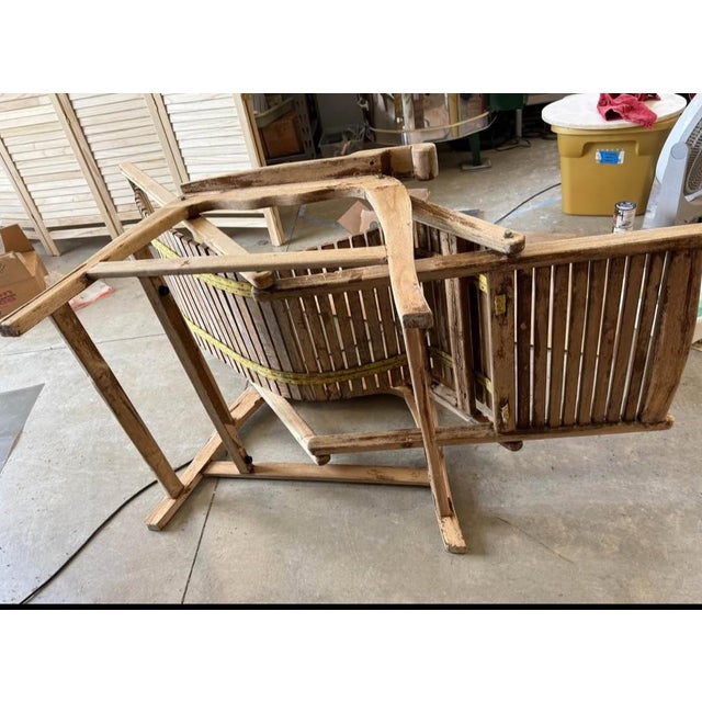 An unusual swinging style steamer ship lounge chair, folding. Made from wood, most likely acacia. Functions as it should....
