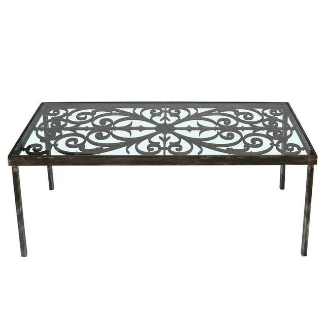 This cocktail table is somewhat rustic yet refined at the same time. The base is wrought iron, featuring a lovely scrolled...