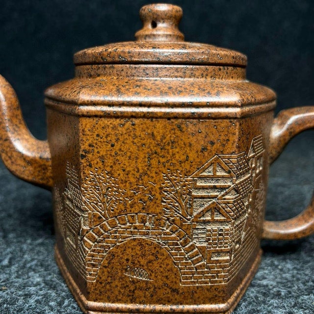 This exquisite teapot is crafted from unglazed, porous clay (Zisha), known for its ability to absorb the flavors of tea...