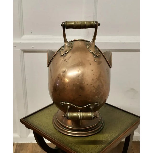 This bucket is a very attractive Enclosed Oval shape, it is made in hand beaten Copper with two handles, with a shovel and...