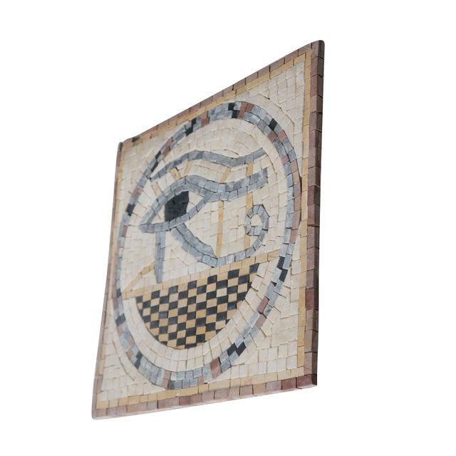 Vintage marble and quartz mosaic tile plaque featuring the Eye of Horus symbol. The piece depicts the Egyptian Eye of...