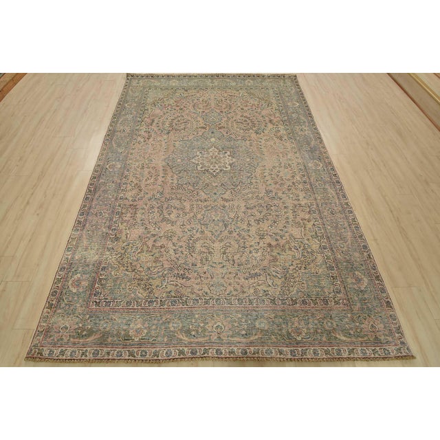 An authentic vintage traditional Tabriz rug hand-knotted with fine wool and natural dyes. This oriental rug features a...