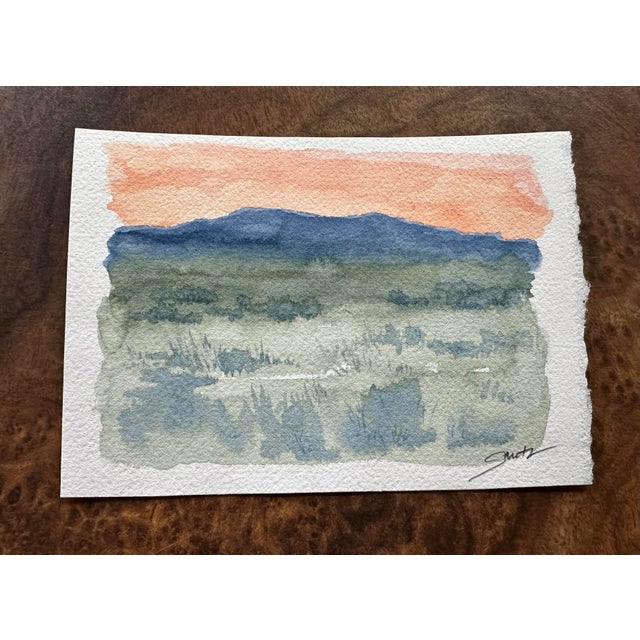 Inspired by the serene beauty of open landscapes, this minimalist watercolor captures the quiet transition from day to...