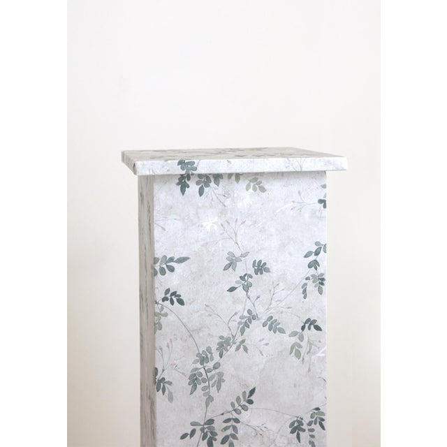 Hand-wrapped wallpaper pedestal in jasmine vine pattern by Sandberg.