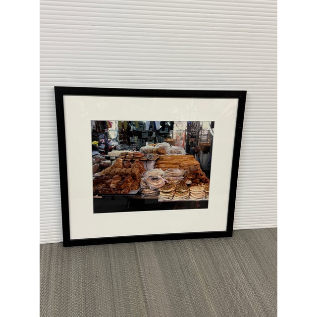 Design Plus Gallery presents a Framed Photograph of Market in the Middle East. The photograph captures a lively market...