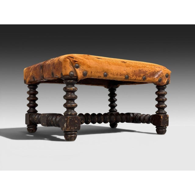 Baroque, Small Footstool, Leather, Turned Walnut, 19th c. A small baroque style footstool or ottoman having a turned...