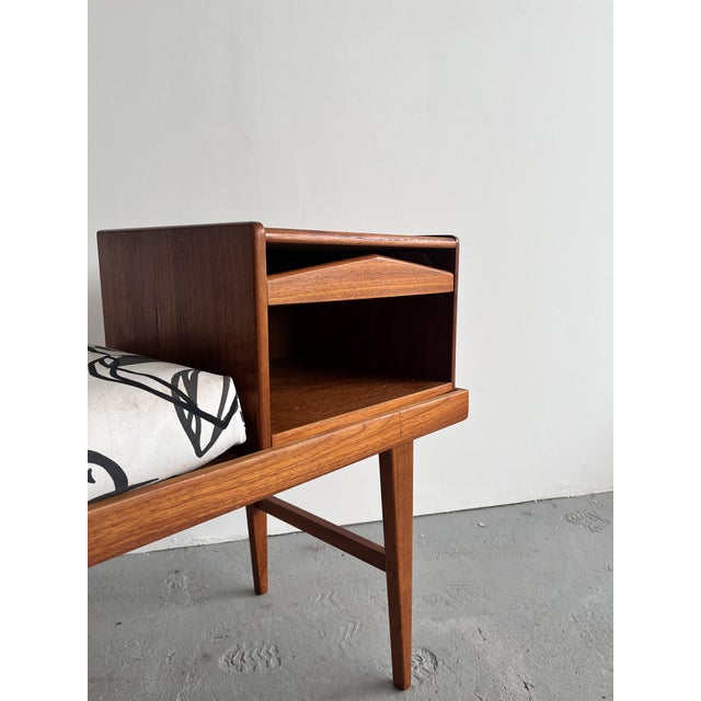 This elegant Scandinavian gossip bench from the 1960s is a beautiful example of functional Mid-Century Modern design....