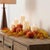 Celebrate the cozy charm of the season with this Plush Pumpkin Fall Spray, featuring soft fabric pumpkins in festive...