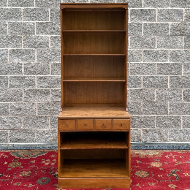 A vintage Ethan Allen Heirloom Nutmeg Maple Custom Room Plan collection 2 piece wall unit consisting of an open base...
