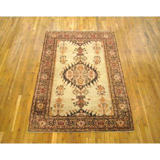 A small antique Persian Tabriz decorative rug, circa 1920. This handsome oriental carpet features a central lozenge...