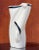 An elegant postmodern vase featuring a cloaked figure by Lindsey B., signed, 1983. Tones of snow and licorice. 5” W x...