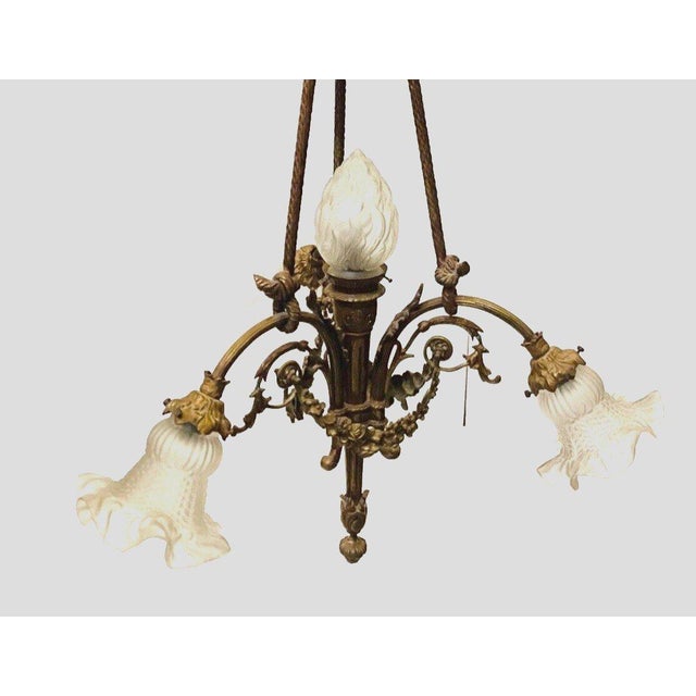 Louis XVI style chandelier in bronze and frosted glass Three-armed frame decorated with garlands Good condition...