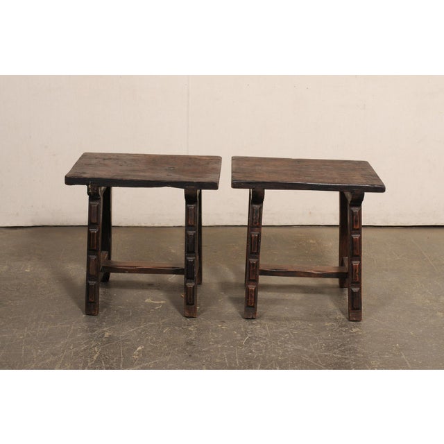 A pair of rustic Italian carved-wood side tables, with trestle legs, from the 19th century. This pair of small antique...