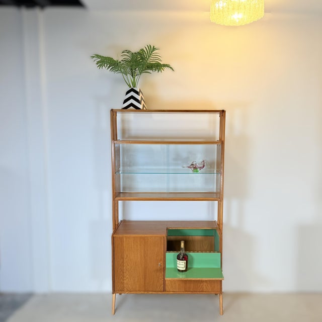 A bar cabinet that serves as a room divider, produced in the 1960s by the former Czechoslovak company Tatra Nábytok. The...