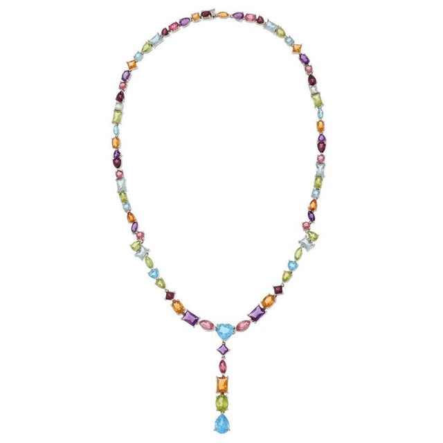 This beautiful necklace is crafted from 14k white gold with a polished finish. It features assorted size and shape frames...