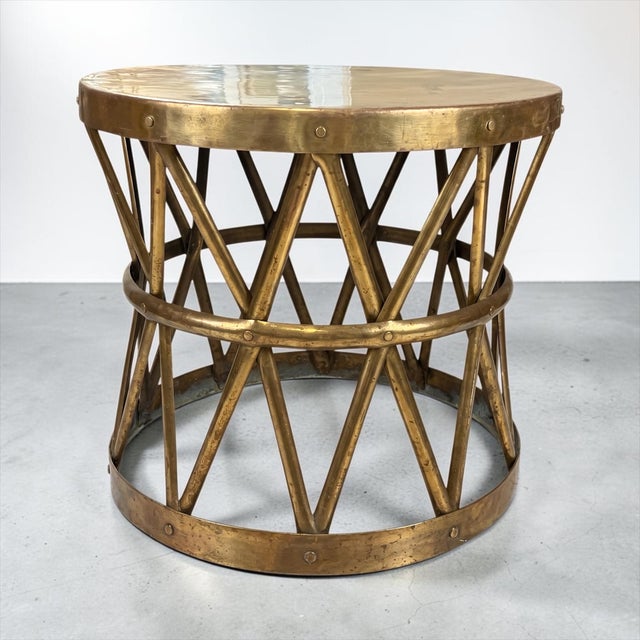 This is a large scale neoclassical campaign style tambour form brass drum side table attributed to Sarreid. It most likely...