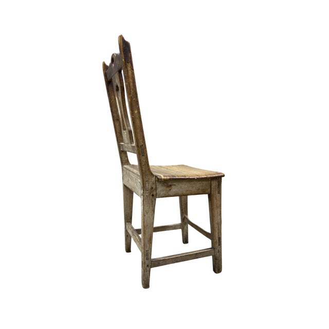 A beautifully timeworn French farmhouse chair crafted from solid wood with a warm, naturally aged patina. Featuring a...