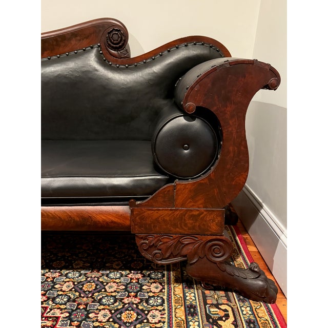 Gorgeous mid-19th century American Empire sofa (circa 1835-1860) with richly figured mahogany veneer and deeply carved...