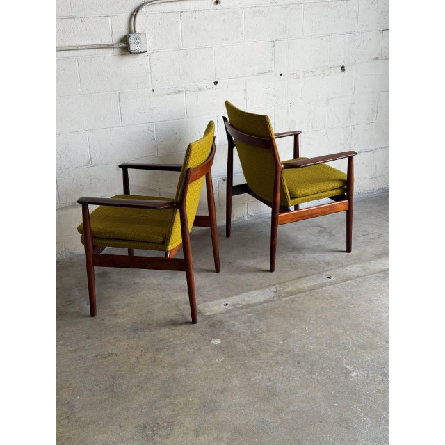 This exceptional pair of seating pieces showcases an elegant low-profile frame with sculpted armrests and a gently angled...