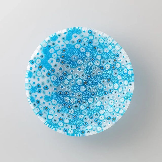 Murano glass bowl made by melting together sections of glass rods in a furnace, with each section depicting a small...