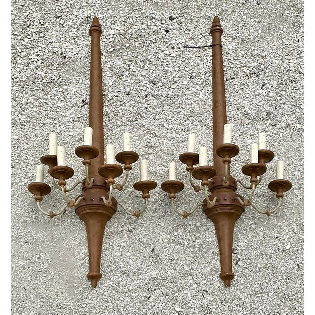 This pair of monumental wall sconces makes a grand architectural statement, reflecting a sophisticated blend of Spanish...