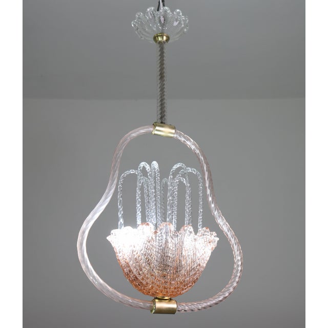 Stunning Murano chandelier by artist Ercole Barovier. The pendant consists of glass elements and a brass structure. In the...