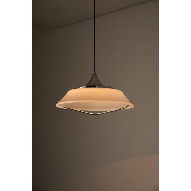 Pendant light from the 1970s, exemplifies the minimalist side of Space Age design. The fixture features a large, shallow...