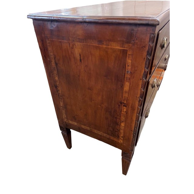 Neoclassical chest of drawers hand-made in Italy in the mid 1700s using walnut and decorated with walnut veneer. The...