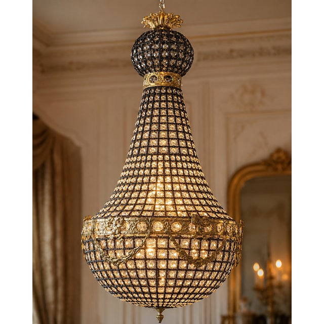 A striking late 20th-century French Louis XVI-style chandelier, featuring a sculptural gold-toned framework wrapped with...
