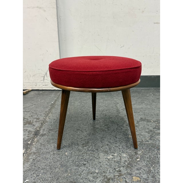 Design Plus Gallery presents a Murphy Three legged Stool from Room & Board. it has a round upholstered seat in deep red...