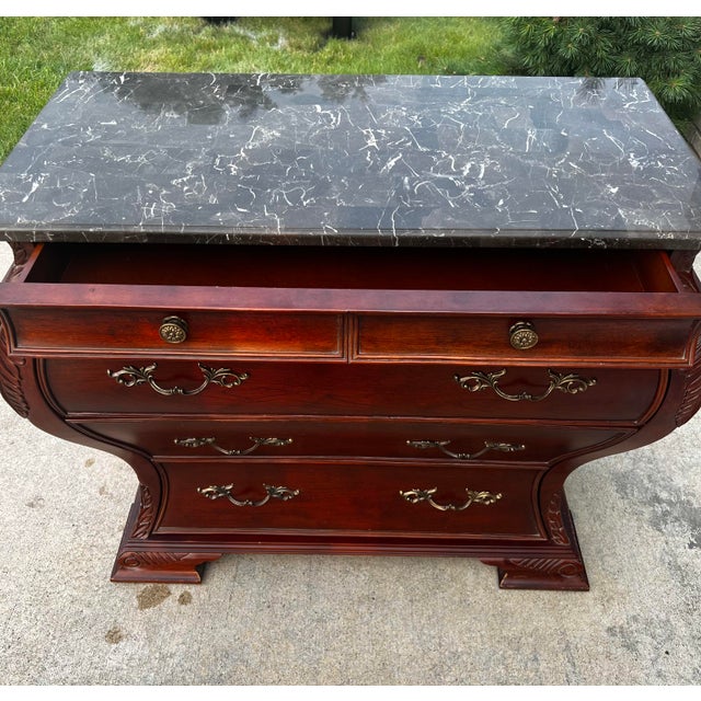 A Bombay® Furniture Co. Marble Top Bombe Chest in a Classic French